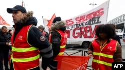 Protesters wear CGT union jacket during a strike of the Eiffel Tower's staff, over the financial management of the monument by the city, closing the monument to the public during the second week of the French school holidays, in Paris, Feb. 20, 2024.