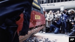 FILE - Fans' cassettes and CDs by singer Sinead O'Connor are flattened by a pavement roller in New York, Oct. 21, 1992. A group now known as the Ellis Island Honors Society, which promotes cultural diversity, planned to deliver the remains to the singer.