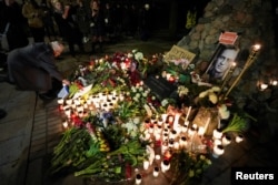 People attend a memorial event following the death of Russian opposition leader Alexey Navalny, in Vilnius, Lithuania, Feb. 16, 2024.