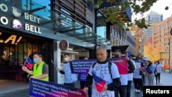 FILE - Chinese migrants protest against Australia's policy shift on the investment visa scheme, as they march outside the Australian Broadcasting Corporation office in Sydney, Australia June 16, 2023.