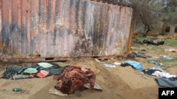 FILE - A picture taken June 16, 2023, shows covered bodies strewn near houses in the West Darfur capital El Geneina, amid ongoing fighting in war-torn Sudan.