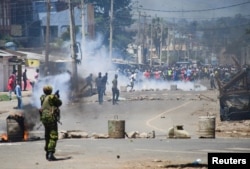 Riot police disperse supporters of Kenya's opposition leader Raila Odinga as they participate in a nationwide protest over cost of living and President William Ruto's government in Kisumu, Kenya, March 30, 2023.