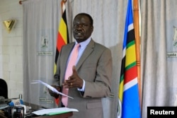 FILE - Hilary Onek, Uganda's Minister for Relief, Disaster Preparedness and Refugees, speaks in the capital Kampala, March 25, 2014.