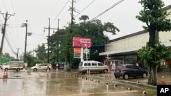 A person walks outside of Aeon Orange supermarket in Yangon, Myanmar, July 1, 2024. Myanmar’s military government has arrested a Japanese business executive, along with dozens of local businessmen, for allegedly selling rice at prices well above the officially regulated ones.