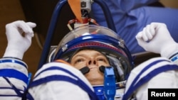 Roscosmos cosmonaut Oleg Kononenko reacts during a check of his space suits before launching to the International Space Station (ISS) at the Russia-leased Baikonur Cosmodrome in Kazakhstan, Sept. 15, 2023.