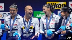 Bill May, second from left, celebrates a silver medal with his U.S. teammates after competing in the team acrobatic final of artistic swimming at the World Swimming Championships in Fukuoka, Japan, July 17, 2023.