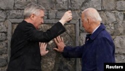 U.S. President Joe Biden and the Rev. Richard Gibbons at Knock Shrine, in Ireland, April 14, 2023. While visiting the shrine, Biden met Frank O'Grady, the priest who performed last rites on his son Beau, who died in the U.S. in 2015 from brain cancer.