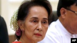 FILE - Myanmar's leader Aung San Suu Kyi, left, attends the bilateral meeting with Chinese President Xi Jinping at the president house in Naypyitaw Myanmar, on Jan. 18, 2020.