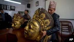 FILE - Masks of Hindu deity Lord Bhairabh dated from 16th century that were stolen from Nepal's Dolakha district are displayed during a press conference at the Department of Archaeology in Kathmandu, Nepal, Jan. 31, 2024.