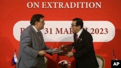 Indonesian Minister of Law and Human Rights Yasonna Laoly, right, talks with Russian Justice Minister Konstantin Chuychenko as they signed an extradition agreement at Nusa Dua, Bali, Indonesia, March 31, 2023.