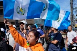 Demonstrators protest in front of Guatemala's Attorney General's Office building in Guatemala City, July 13, 2023. The office announced July 12 that a judge had suspended the legal status of the Seed Movement political party for alleged violations.