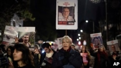 Demonstrators gather to protest Prime Minister Benjamin Netanyahu's reported decision to recall Israeli representatives from cease-fire negotiations, in Jerusalem, Feb. 14, 2024. 