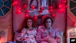 This image released by Focus Features shows Kathryn Newton, left, and Cole Sprouse in a scene from "Lisa Frankenstein." (Michele K. Short/Focus Features via AP)