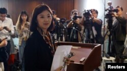 Legislator Eunice Yung, daughter-in-law of Elmer Yuen, one of the eight overseas activists wanted by the police, speaks to the media after being taken to the police station for investigation in Hong Kong, China, July 24, 2023. 