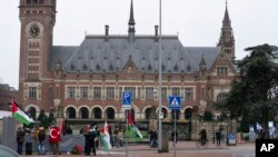Pro-Palestinian, left, and pro-Israeli demonstrators, right, protest outside the United Nations' highest court during hearings in The Hague, Netherlands, Feb. 21, 2024, into the legality of Israel's occupation of the West Bank and east Jerusalem.
