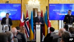 Britain's Defense Secretary Grant Shapps, center, takes part in a press conference with Norway's Minister of Defense Bjorn Arild Gram, left, and Vice Admiral Oleksii Neizhpapa of Ukraine, right, in London, Dec. 11, 2023. 