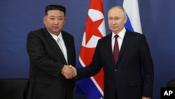 FILE - Russian President Vladimir Putin, right, and North Korean leader Kim Jong Un shake hands during their meeting in Tsiolkovsky, Russia, on Sept. 13, 2023.