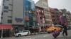 A six story glass facade building, pictured second from left in New York's Chinatown, April 17, 2023, is believed to be the site of a foreign police outpost for China.