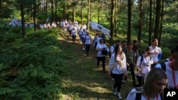 People march in memory of the 1995 Srebrenica massacre, in Nezuk, Bosnia, July 8, 2023. 