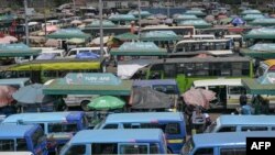 FILE - Kenyan public transport, known locally as matatu, queue to transport passengers in Nairobi, Sept. 12, 2023. 