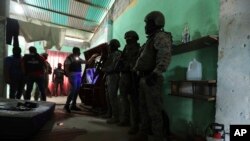 FILE - Police and soldiers conduct a joint operation searching for drugs and weapons in a neighborhood of Duran, Ecuador, Feb. 1, 2024. On Jan. 8, President Daniel Noboa declared a national state of emergency due to a wave in crime.