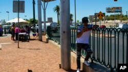 A man hides under what little shade was available, July 14, 2023 in Las Vegas. 