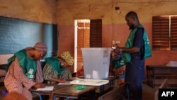 FILE - Election officials start to count the ballots in Mali's referendum in Bamako on June 18, 2023. On Sept. 25, 2023, Mali's military-led government postponed a February 2024 election that was expected to return democracy to the nation following a 2020 coup. 
