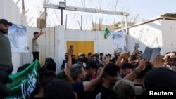 Protesters gather at the entrance to the Swedish embassy in Baghdad, Iraq, a day after a man tore up and burned a copy of the Quran outside a mosque in the Swedish capital Stockholm, Iraq, June 29, 2023.