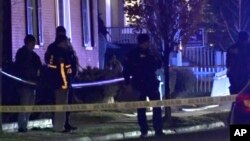 Law enforcement officers stand by police tape near a scene where three men of Palestinian descent were shot and injured, in Burlington, Vermont, Nov. 25, 2023, in this still frame from video provided by WCAX-TV. (WCAX-TV via AP)