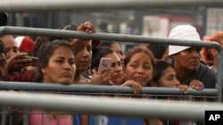 Friends and family members of inmates wait to hear news about their loved ones after deadly clashes at the Litoral Penitentiary, in Guayaquil, Ecuador, July 25, 2023. 