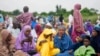 Nigerian Muslim women and children attend Eid al-Adha prayers at an open field in Lagos, June 28, 2023
