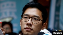 FILE - Pro-democracy activist Nathan Law is interviewed by journalists outside the Final Court of Appeal after being granted bail in Hong Kong, China Oct. 24, 2017. 