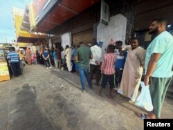 People gather to get bread during clashes between the paramilitary Rapid Support Forces and the army in Khartoum, Sudan, April 18, 2023.