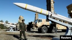 Iran's Defense Minister Brigadier General Mohammad-Reza Ashtiani walks near an Iranian missile during an unveiling ceremony in Tehran, Iran, in this picture obtained on Feb. 17, 2024. (Iran's Defense Ministry/WANA via Reuters)