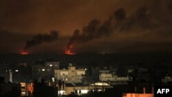 A picture taken from Rafah shows smoke billowing following Israeli bombardment of Khan Yunis in the southern Gaza Strip on Dec. 9, 2023, amid continuing battles between Israel and the militant group Hamas. 
