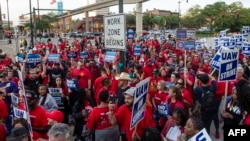 Members of the United Auto Workers (UAW) union march through the streets of downtown Detroit following a rally on the first day of the UAW strike in Detroit, Michigan, on Sept. 15, 2023. 