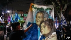 Supporters of Sergio Massa, presidential candidate for the ruling party, display a banner portraying former Presidents Nestor Kirchner and Cristina Fernandez at his campaign headquarters after general elections in Buenos Aires, Argentina, Oct. 22, 2023.