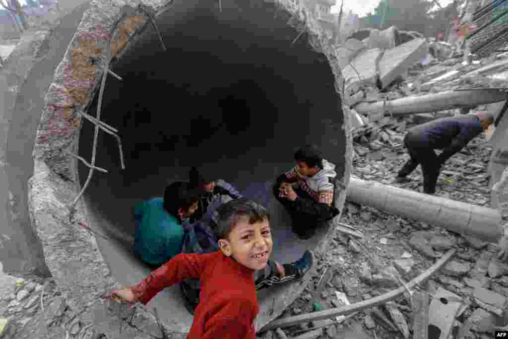 Children play in one of the fallen domes of the Al-Faruq mosque, leveled by Israeli bombardment in Rafah in the southern Gaza Strip, Feb. 25, 2024.