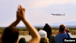 People watch as the passenger rocket plane operated by Virgin Galactic takes off during the company's first commercial flight to the edge of space, at the Spaceport America facility in Truth or Consequences, N.M., June 29, 2023.