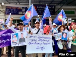 អ្នកគាំទ្រគណបក្សកម្លាំងជាតិ កាន់រូបថត បដា និងស្រែកទាមទារឱ្យដោះលែងសកម្មជននយោបាយ នៅខាងមុខទីស្នាក់ការគណបក្សកម្លាំងជាតិ សង្កាត់ចាក់អង្រែក្រោម ខណ្ឌមានជ័យ នៅថ្ងៃទី២២ ខែមេសា ឆ្នាំ២០២៤។ (លាស់ លីបលីប/វីអូអេ)