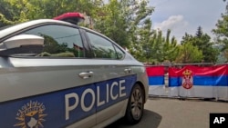 Kosovo Serbs block the street near the municipal building in the town of Zvecan, northern Kosovo, June 5, 2023. 