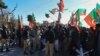 Police personnel stand guard as supporters of Pakistan Tehreek-e-Insaf and other parties protest against alleged rigging of Pakistan's national election results outside the office of a Returning Officer, Feb. 9, 2024, in Quetta, Pakistan.