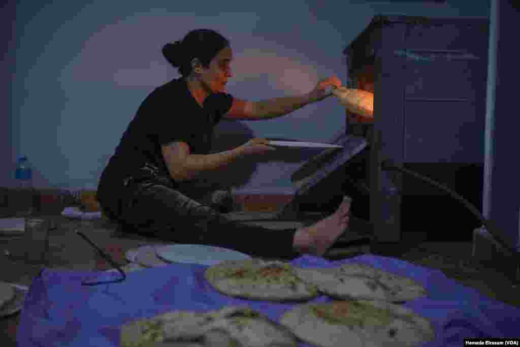 Omu Abanoub makes bread. &ldquo;The subsidized bakeries usually shut down early in the day, so we aren&rsquo;t able to get our loaves every day,&rdquo; the mother says, since she works two low-paying jobs and her children are in school. Cairo, Egypt, June 25, 2024.&nbsp;(Hamada Elrasam/VOA)