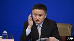 FILE - Pan Gongsheng, as deputy governor of the People's Bank of China, answers questions at news conference during the 12th National People's Congress in Beijing on March 10, 2017.