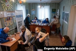 FILE - Medical volunteers of FRIDA Ukraine examine patients while providing medical care for civilians in Donetsk area, Ukraine on March 19, 2023. (AP Photo/Evgeniy Maloletka)