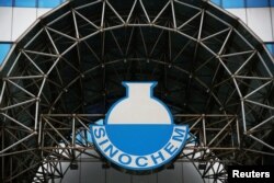 FILE - A logo of Sinochem is seen outside an office building of Sinochem in Beijing, China, Feb. 21, 2017.