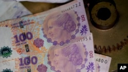 FILE - Argentine banknotes printed with the face of former first lady Eva Perón, are on display at the Peron Peron restaurant in the San Telmo neighborhood of Buenos Aires, Argentina, Feb. 9, 2024.