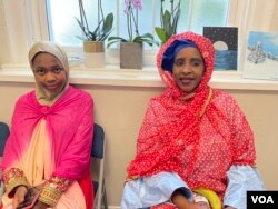 Jemaah asal Gambia, Nduie Jallow (kanan) dan anaknya, salat Iduladha di Masjid Imaam Center. (foto: VOA/Karlina)