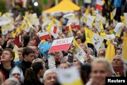 FILE - Catholic faithful celebrate the canonisation of Pope John XXIII and John Paul II in the hometown of Karol Wojtyla, who later become Pope John Paul II, in Wadowice, Apr. 27, 2014. (Reuters/Agencja Gazeta/Michal Lepecki)
