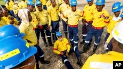 South African firefighters gather for a safety briefing in Fox Creek, Alberta, on Tuesday, July 4, 2023. Several countries, including South Africa, deployed firefighters to Canada to help local efforts to control widespread wildfires. 